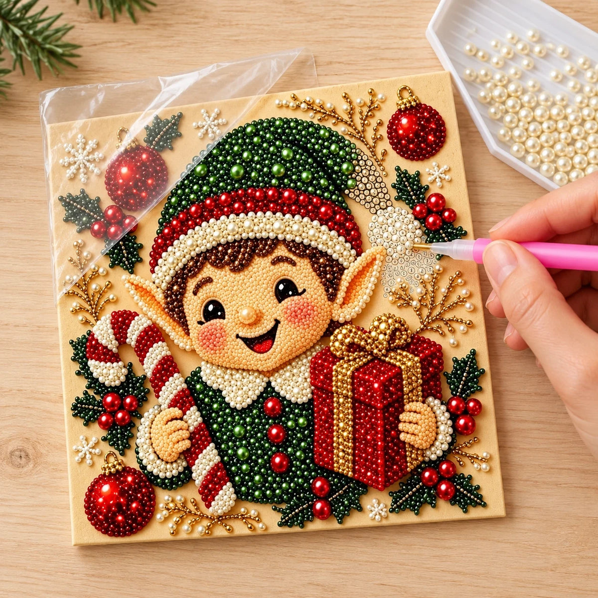 Illustrated process of placing pearls on the Christmas Elf Gift printed canvas