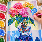 Hand placing resin diamonds on pastel hydrangea bouquet canvas