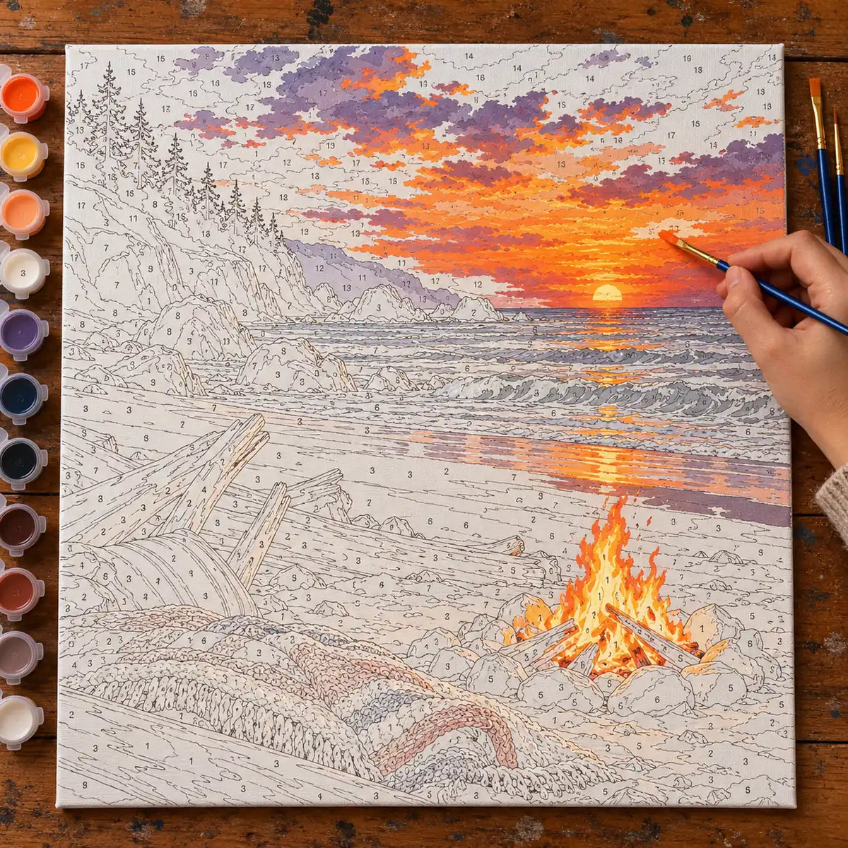 Complete Bonfire Beach Autumn Equinox Paint by Numbers Kit numbered canvas being painted with acrylic paints and brushes.
