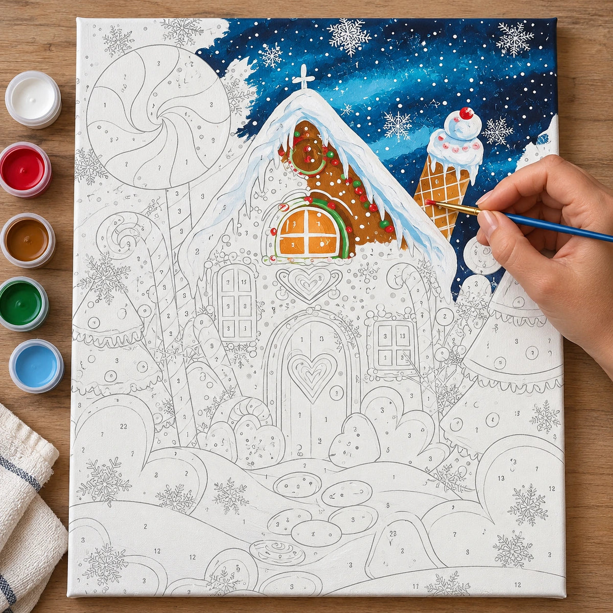 Complete Candyland Gingerbread Christmas numbered canvas being painted with acrylic paints and brushes