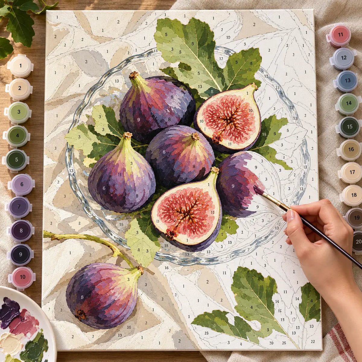 `04-figs-cut-glass-dish-painting-process.webp` — Painting process scene for the Figs Cut Glass Dish kit, with the complete numbered canvas and painting tools.