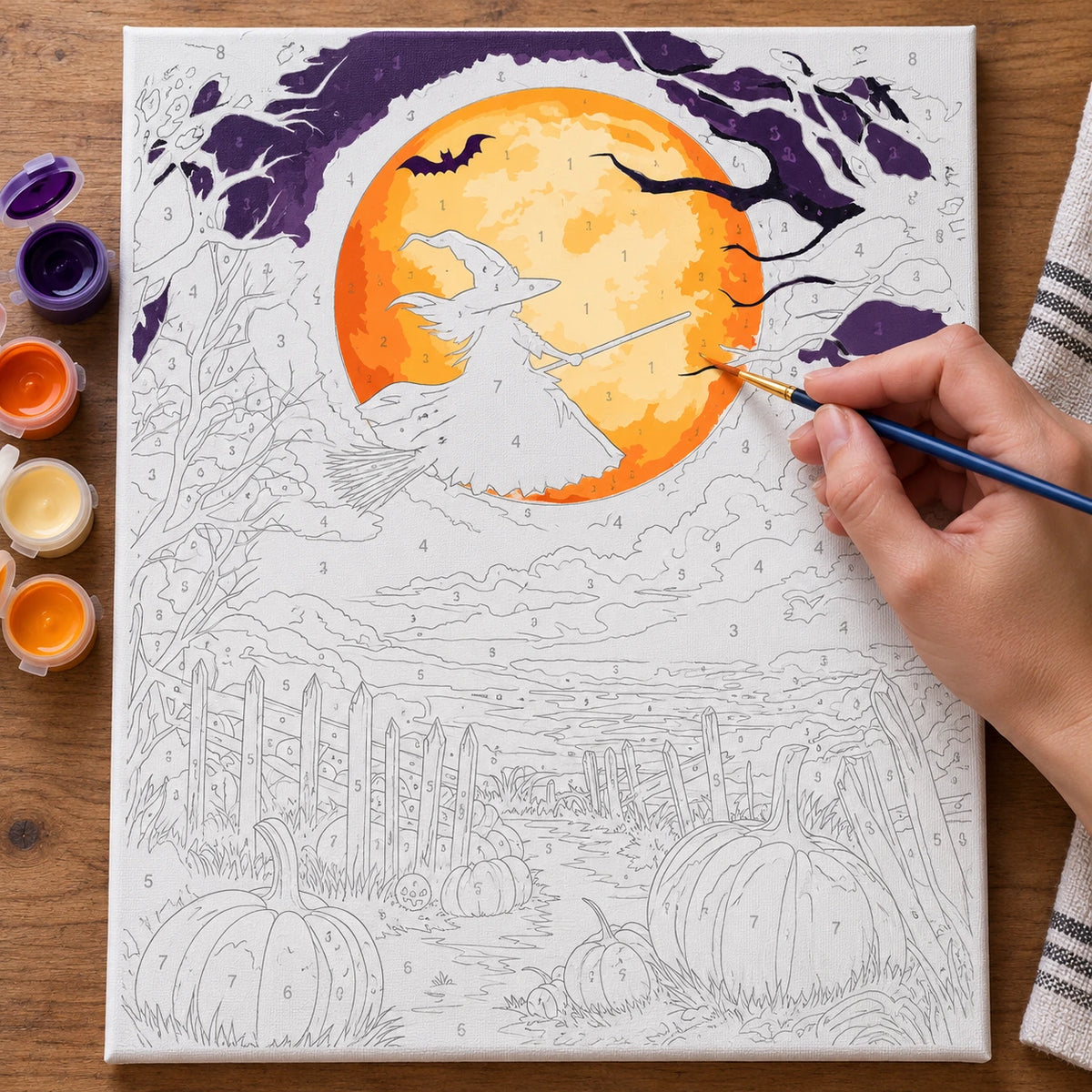 Complete Flight of the Harvest Witch numbered canvas being painted with acrylic paints and brushes