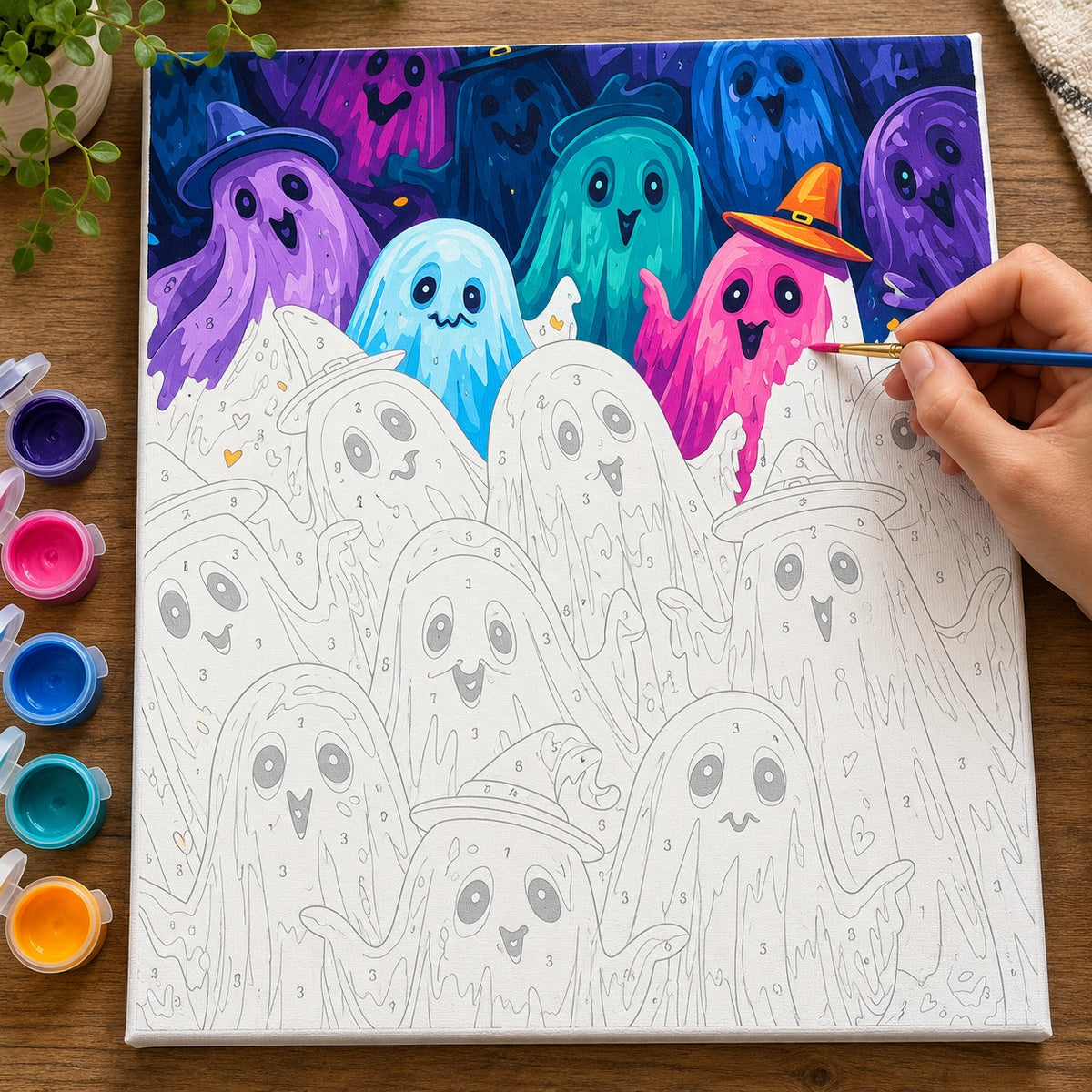 Complete Halloween Ghost Parade numbered canvas being painted with acrylic paints and brushes