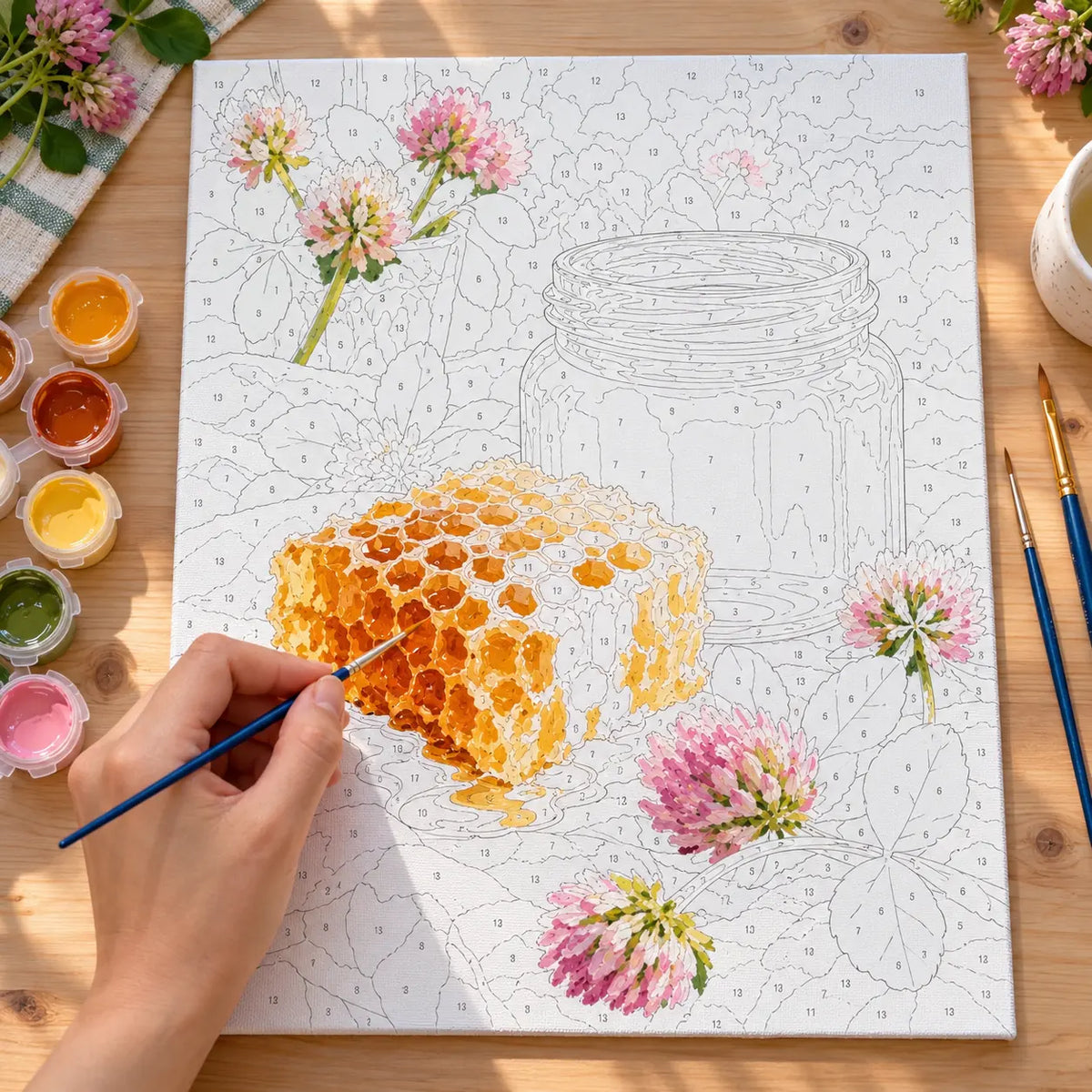 Painting process scene for the Honeycomb Jar Spring Clover kit, with the complete numbered canvas and painting tools.