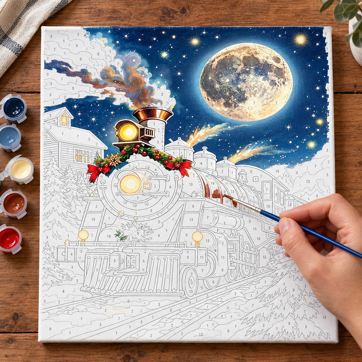 Complete Moonlit Christmas Express Train numbered canvas being painted with acrylic paints and brushes