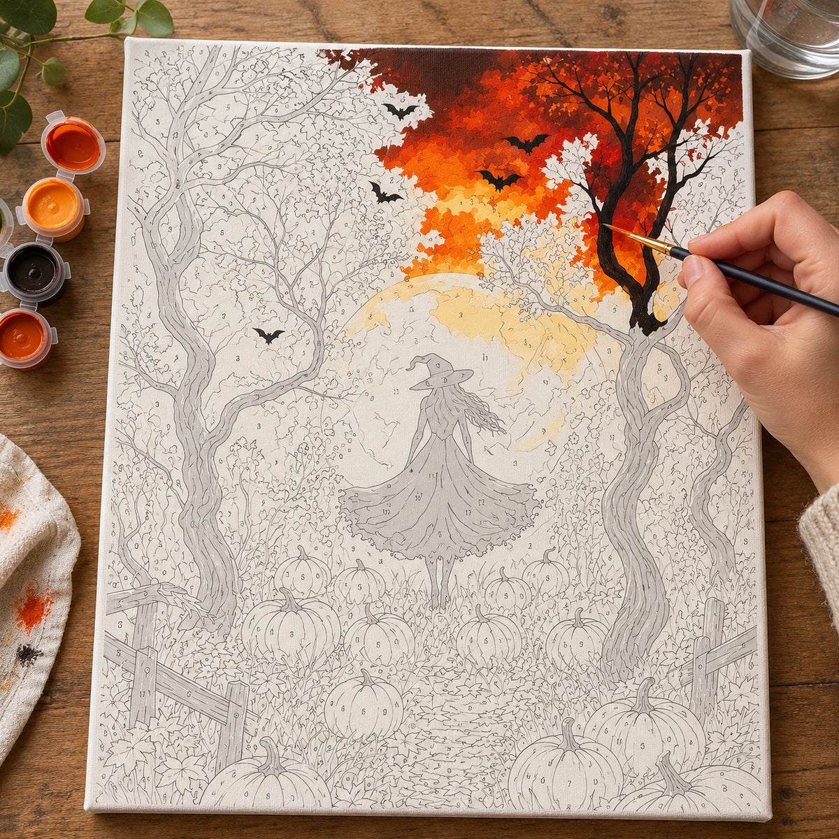Complete Moonlit Witch Among Pumpkins numbered canvas being painted with acrylic paints and brushes