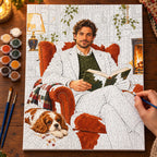 Painting process scene for the Man Reading in an Armchair with a Spaniel kit, showing its complete numbered canvas and painting tools.