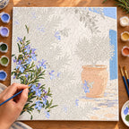 Numbered blue flower and bee canvas being painted with acrylic colors.