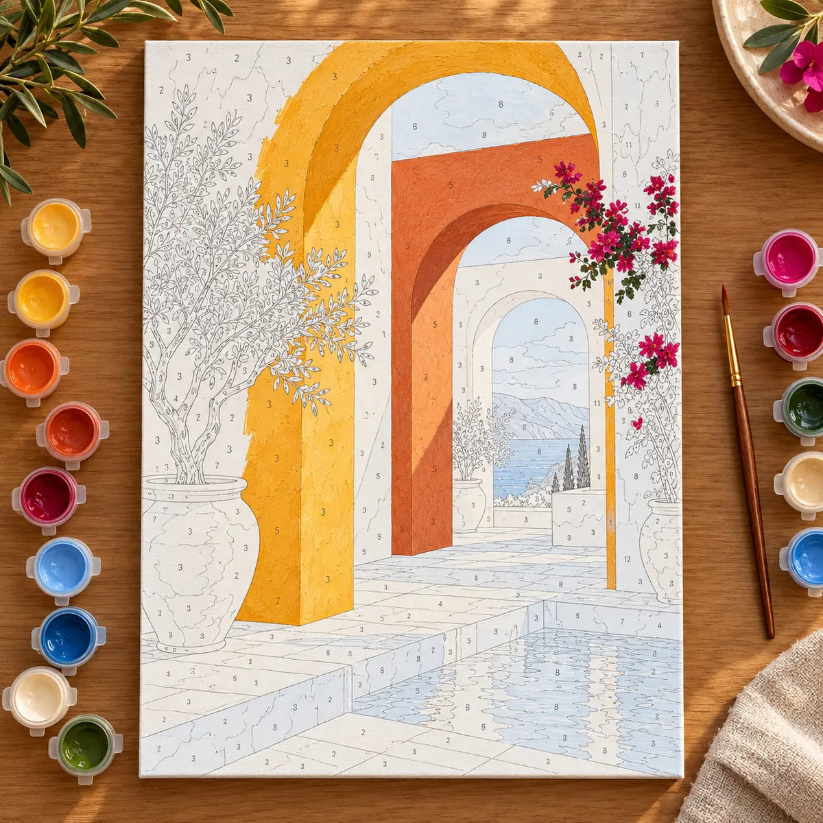 Painting process scene for the Saffron Arches Sea View kit, with the complete numbered canvas and painting tools.