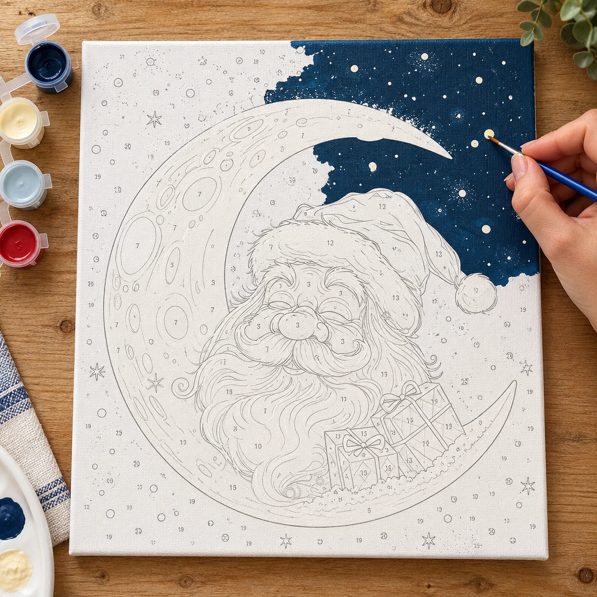 Complete Santa’s Crescent Moon Night numbered canvas being painted with acrylic paints and brushes