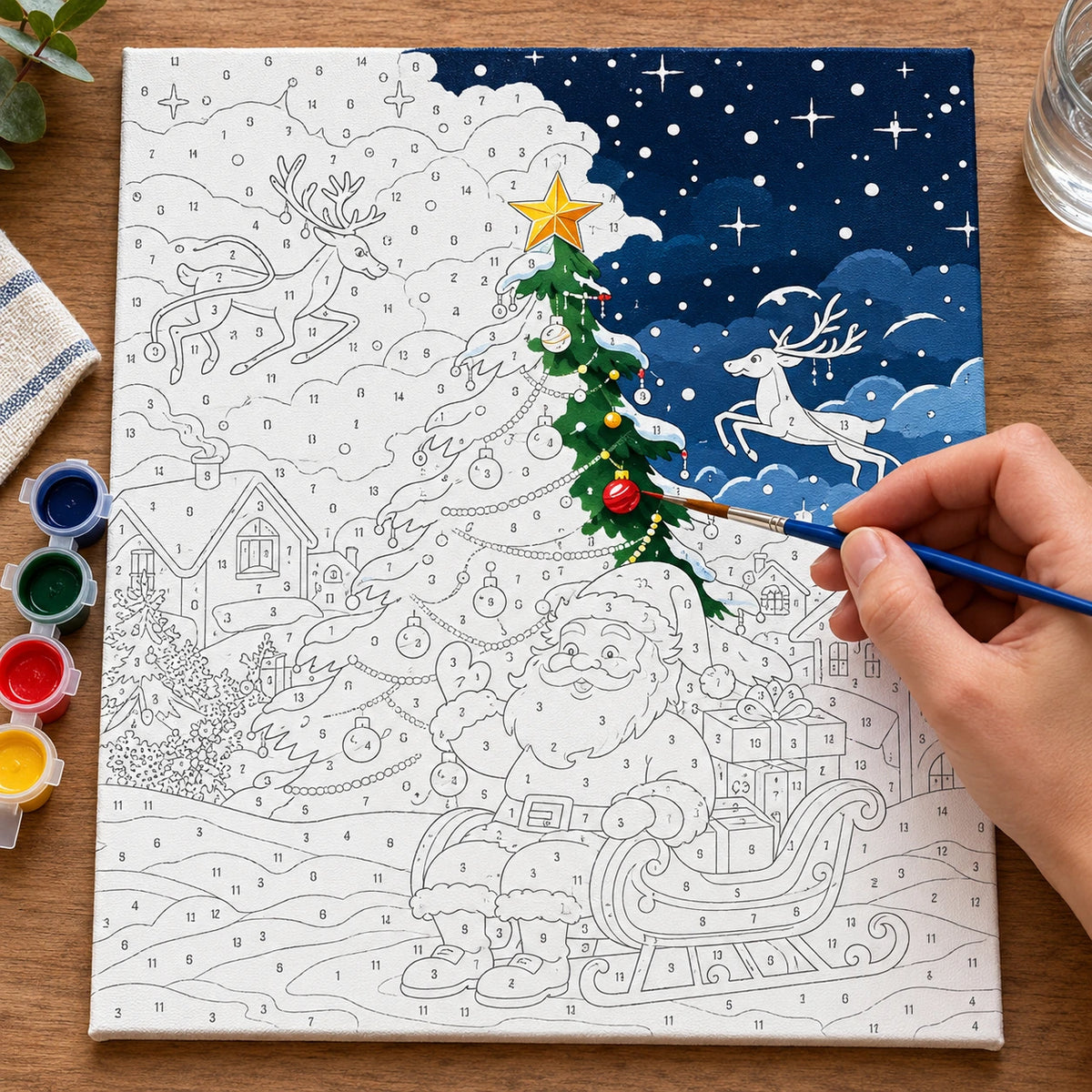 Complete Santa’s Snowy Sleigh with Reindeer numbered canvas being painted with acrylic paints and brushes