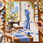 `04-sewing-room-blue-linen-painting-process.webp` — Painting process scene for the Sewing Room Blue Linen kit, with the complete numbered canvas and painting tools.