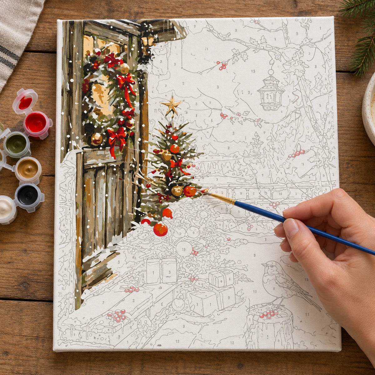 Complete Snowbound Christmas Grove numbered canvas being painted with acrylic paints and brushes