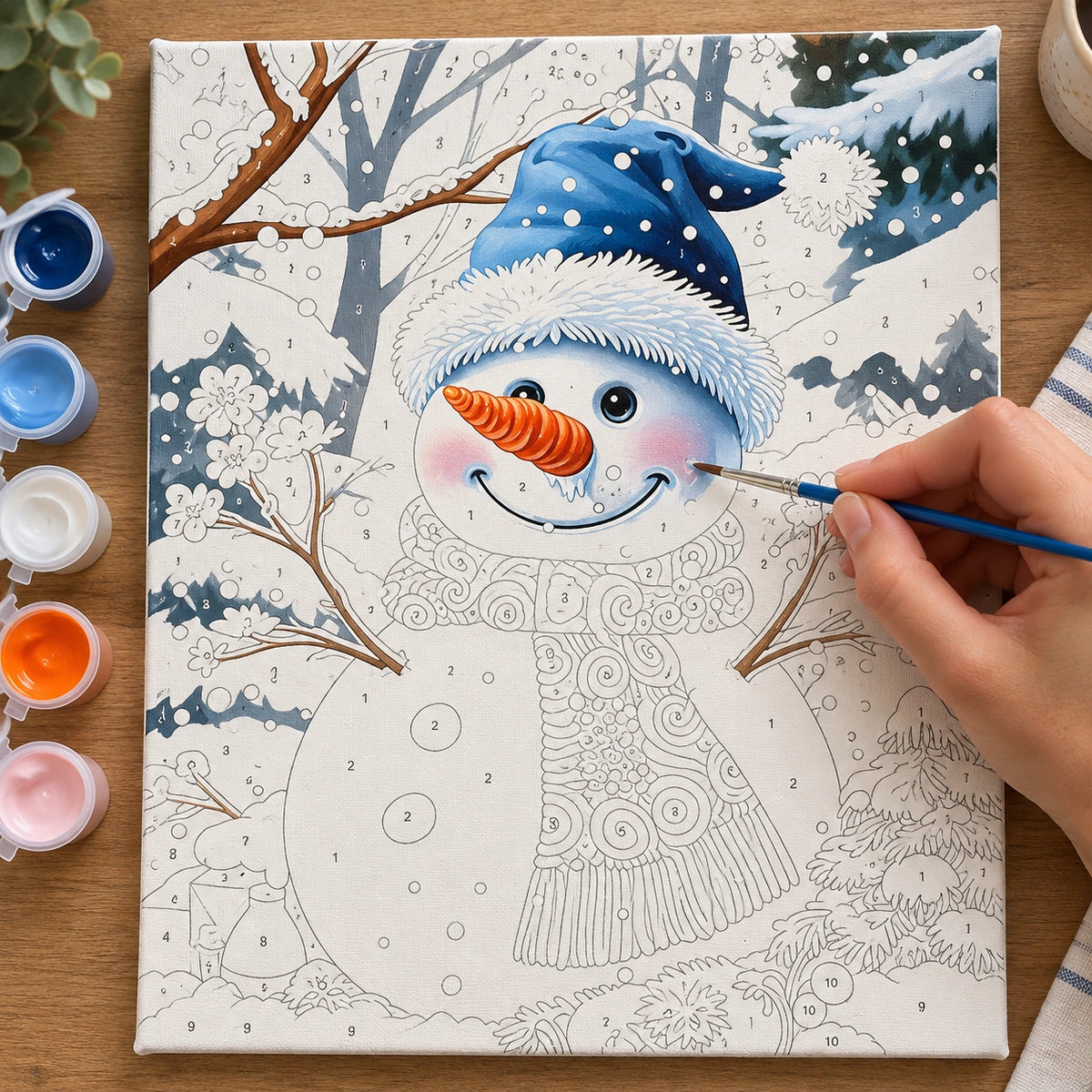 Complete Snowman Winter Garden numbered canvas being painted with acrylic paints and brushes