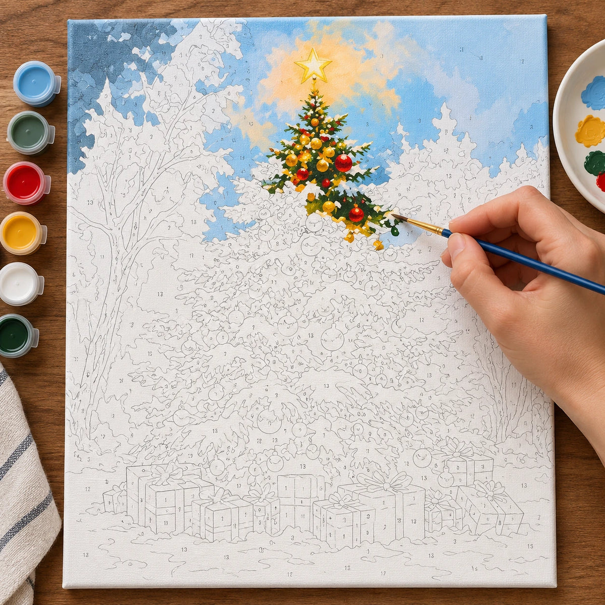 Complete Star Above the Snowy Tree numbered canvas being painted with acrylic paints and brushes