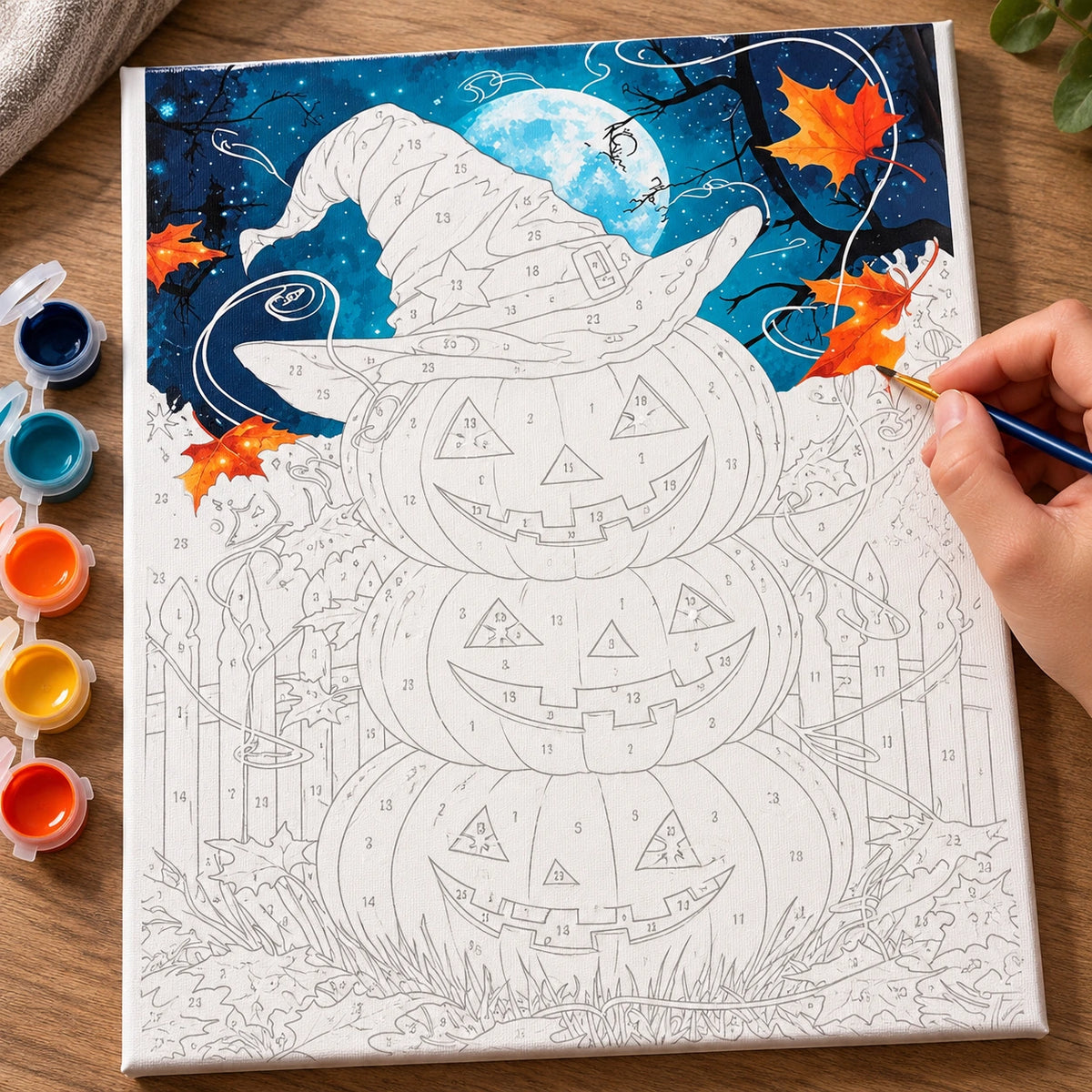 Complete Witching Hour Pumpkins numbered canvas being painted with acrylic paints and brushes