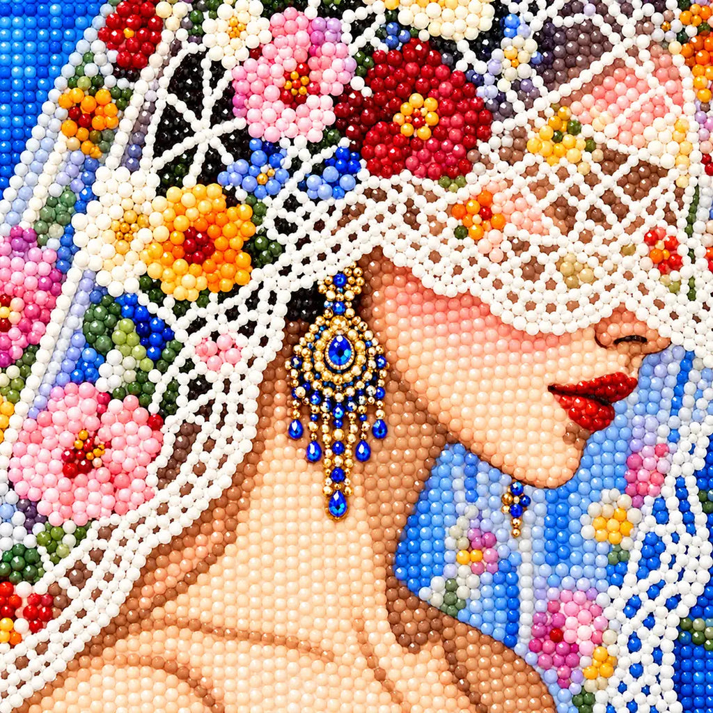 Close-up diamond drill detail of the bride’s floral lace veil and profile