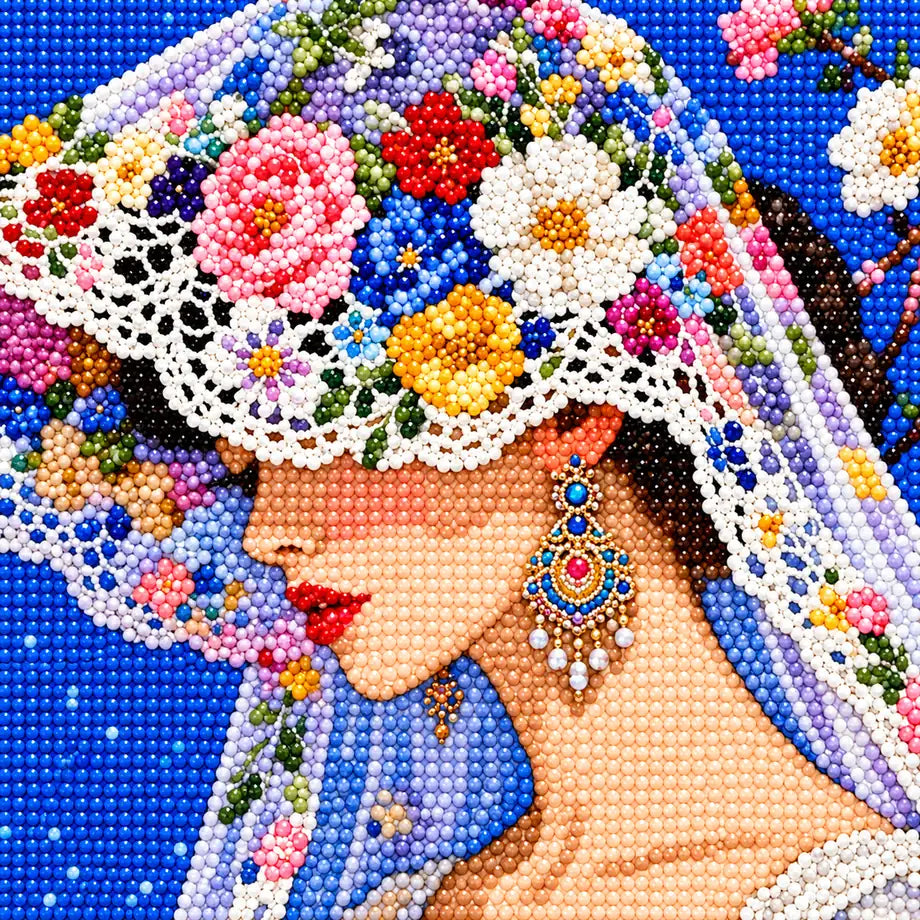 Close-up diamond drill detail of the bride’s floral hat, veil, and portrait