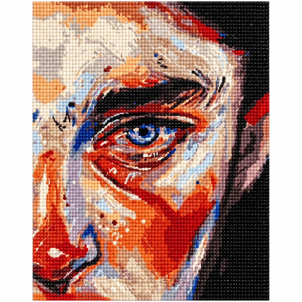 Finished diamond painting of an abstract blue-eye portrait in orange, cream, and cobalt.