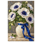 White anemones with deep navy centers and green leaves in a ceramic vase tied with a cobalt ribbon: finished diamond painting on a clean white background