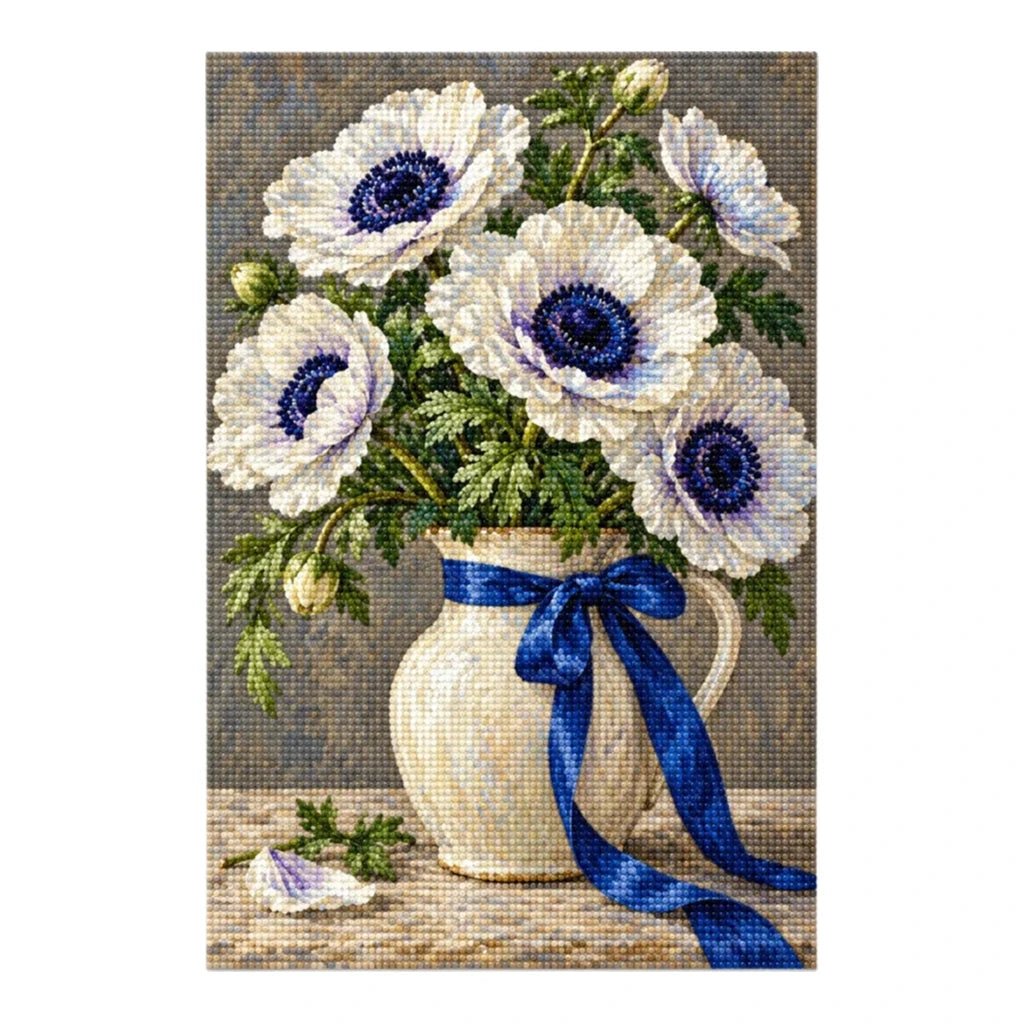 White anemones with deep navy centers and green leaves in a ceramic vase tied with a cobalt ribbon: finished diamond painting on a clean white background