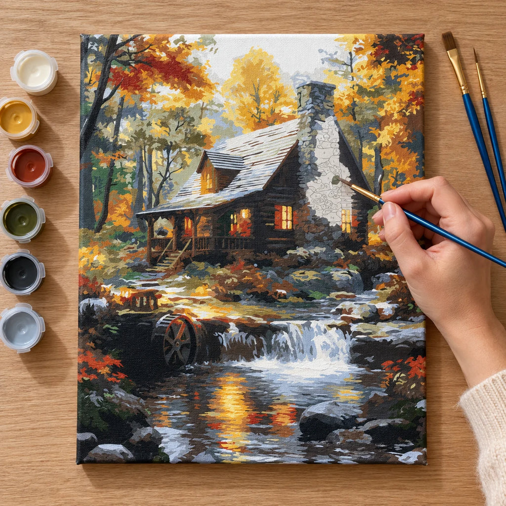 Complete Autumn Cabin by Waterfall numbered canvas being painted with acrylic paints and brushes