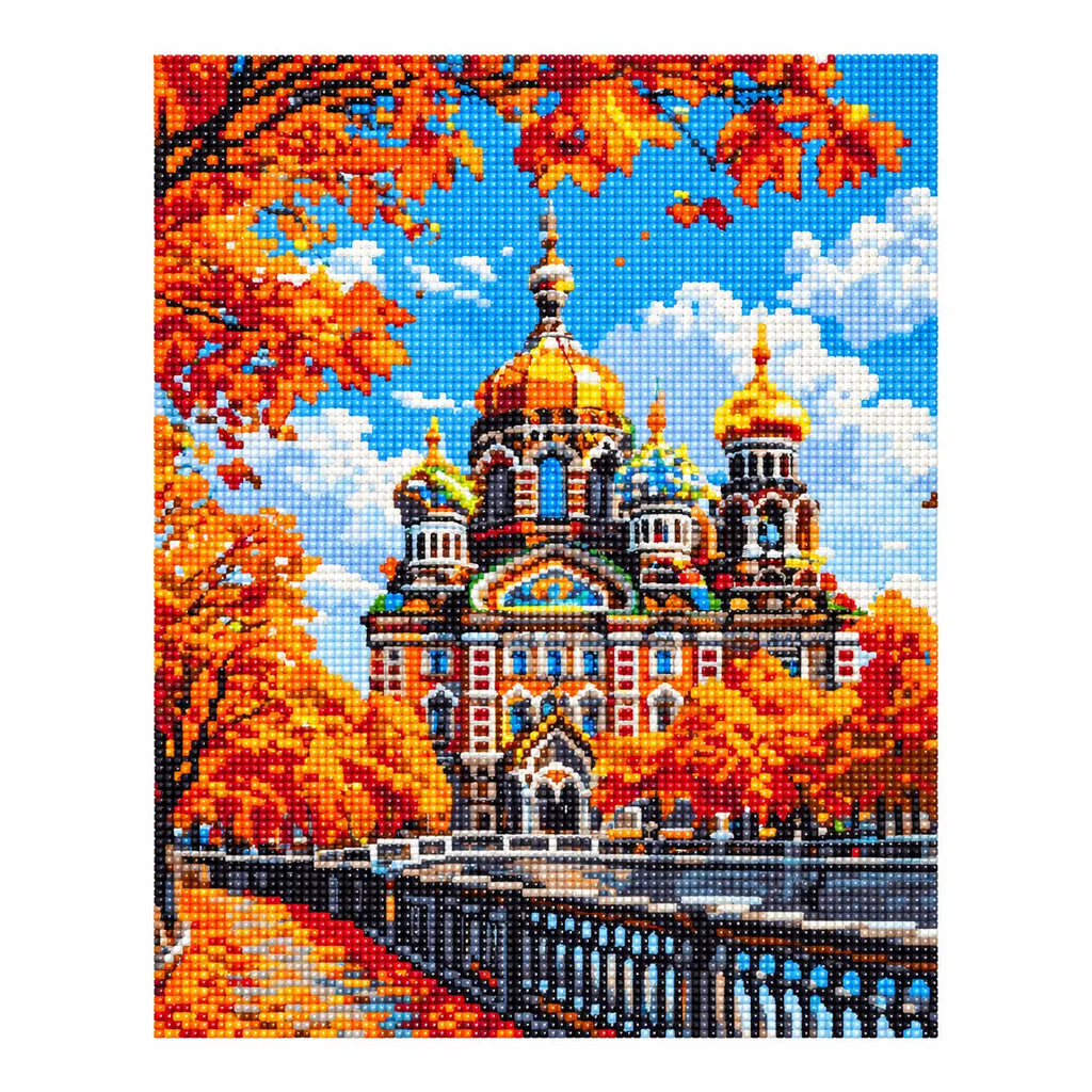 Finished diamond painting showing an ornate cathedral with golden domes among orange autumn leaves.