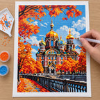 Hands applying drills to a canvas showing an ornate cathedral with golden domes among orange autumn leaves.