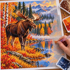 Hands placing diamond drills on the Autumn Moose design.