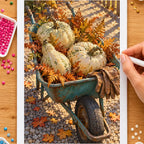 Hands placing drills on the autumn teal wheelbarrow with pumpkins diamond painting canvas
