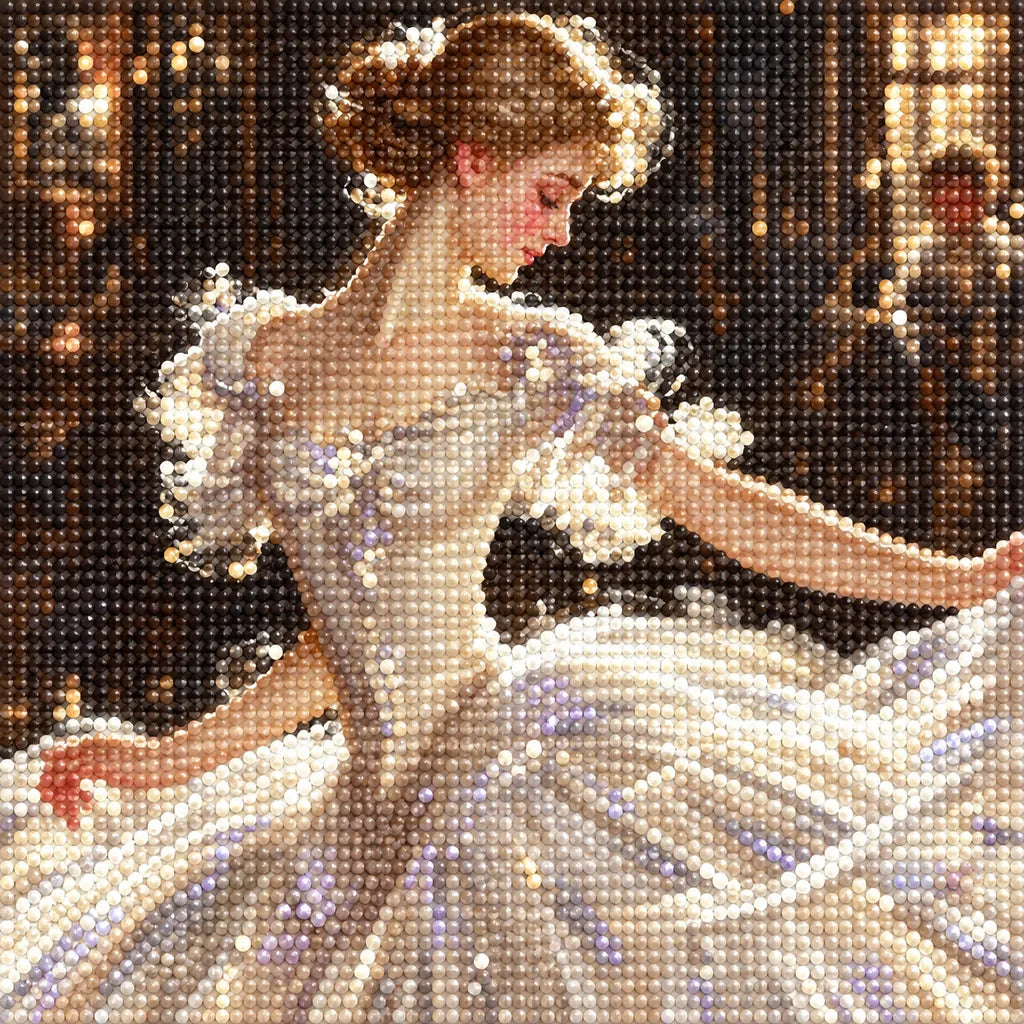 Close-up of diamond drills on artwork of a ballerina in a flowing dress dancing in a warmly lit studio.