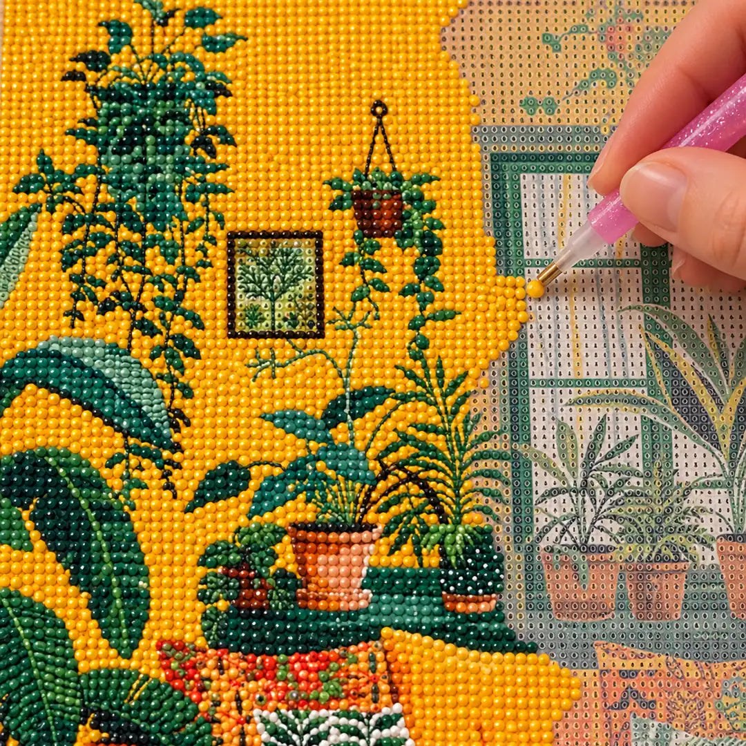 Diamond painting process showing a black cat in a plant-filled golden room being completed with a stylus