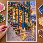 A hand places drills on the Blue Door bookshop diamond painting canvas.