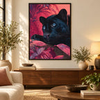 Framed home decor scene featuring a diamond painting of a blue-eyed black panther surrounded by magenta foliage displayed on a wall.