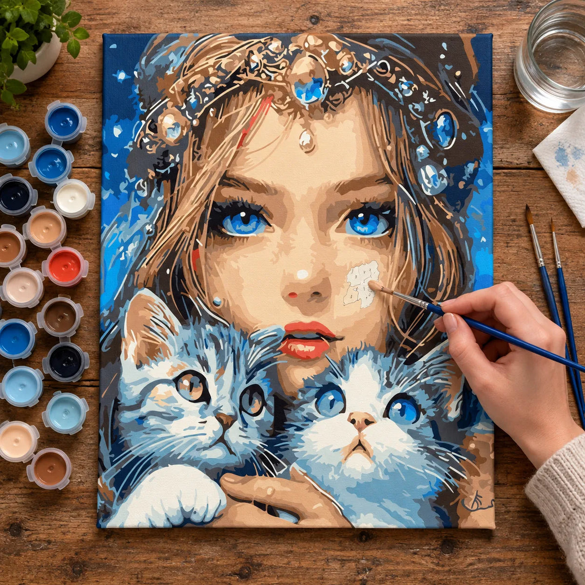 Complete Blue-Eyed Woman with Two Kittens numbered canvas being painted with acrylic paints and brushes