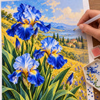 Blue irises among golden field grasses: diamond painting being completed with a pen