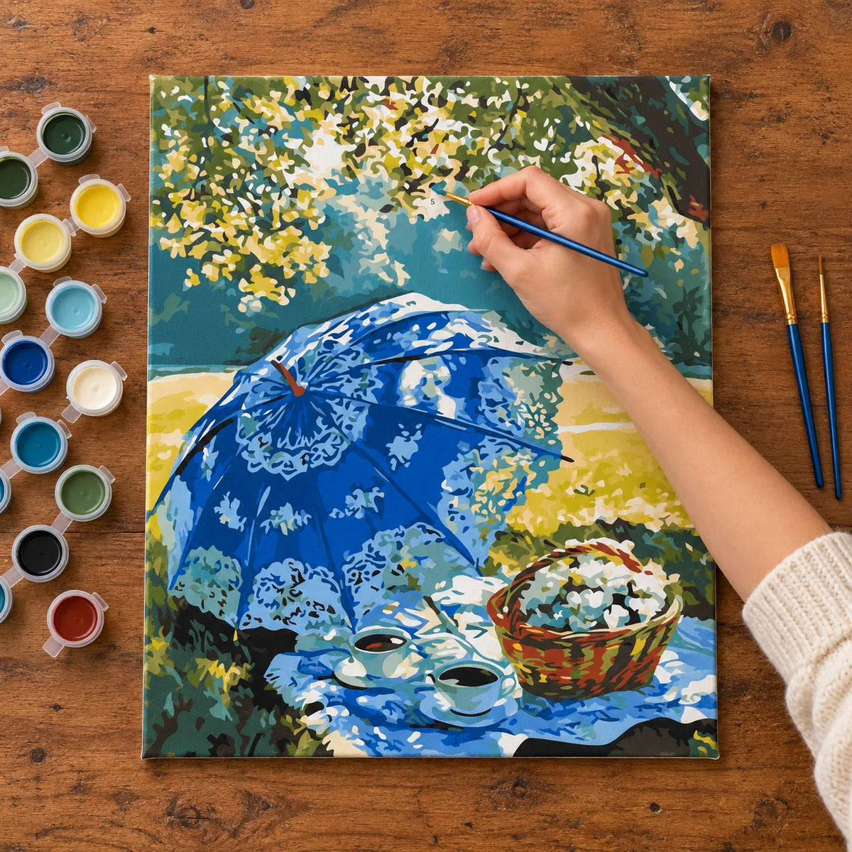 Complete Blue Parasol Picnic numbered canvas being painted with acrylic paints and brushes
