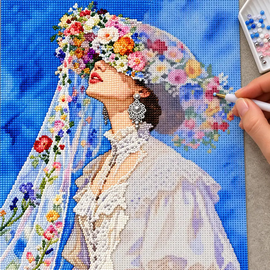Diamond painting process showing the upturned bride portrait being completed with a stylus