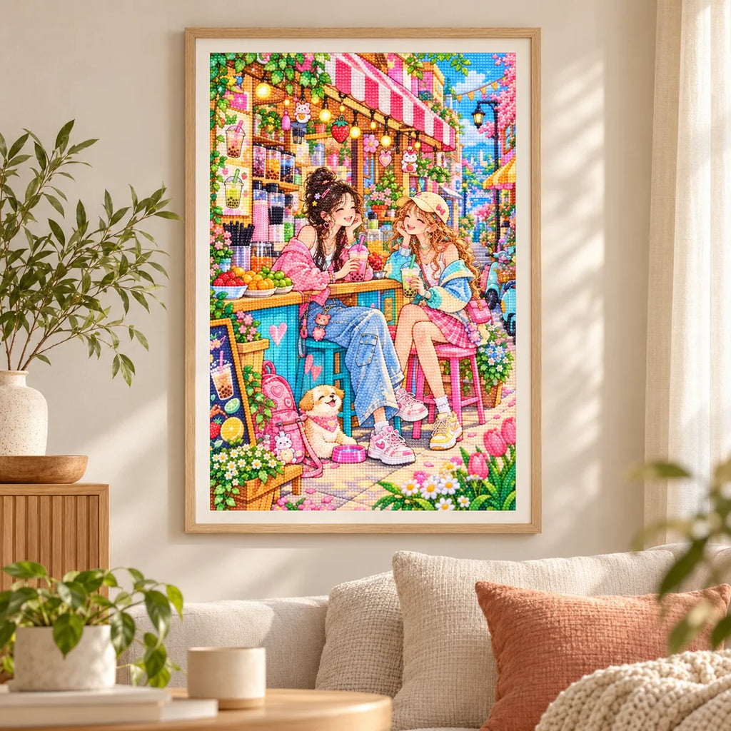 Framed diamond painting of two friends sharing bubble tea in a bright cafe displayed in a home interior