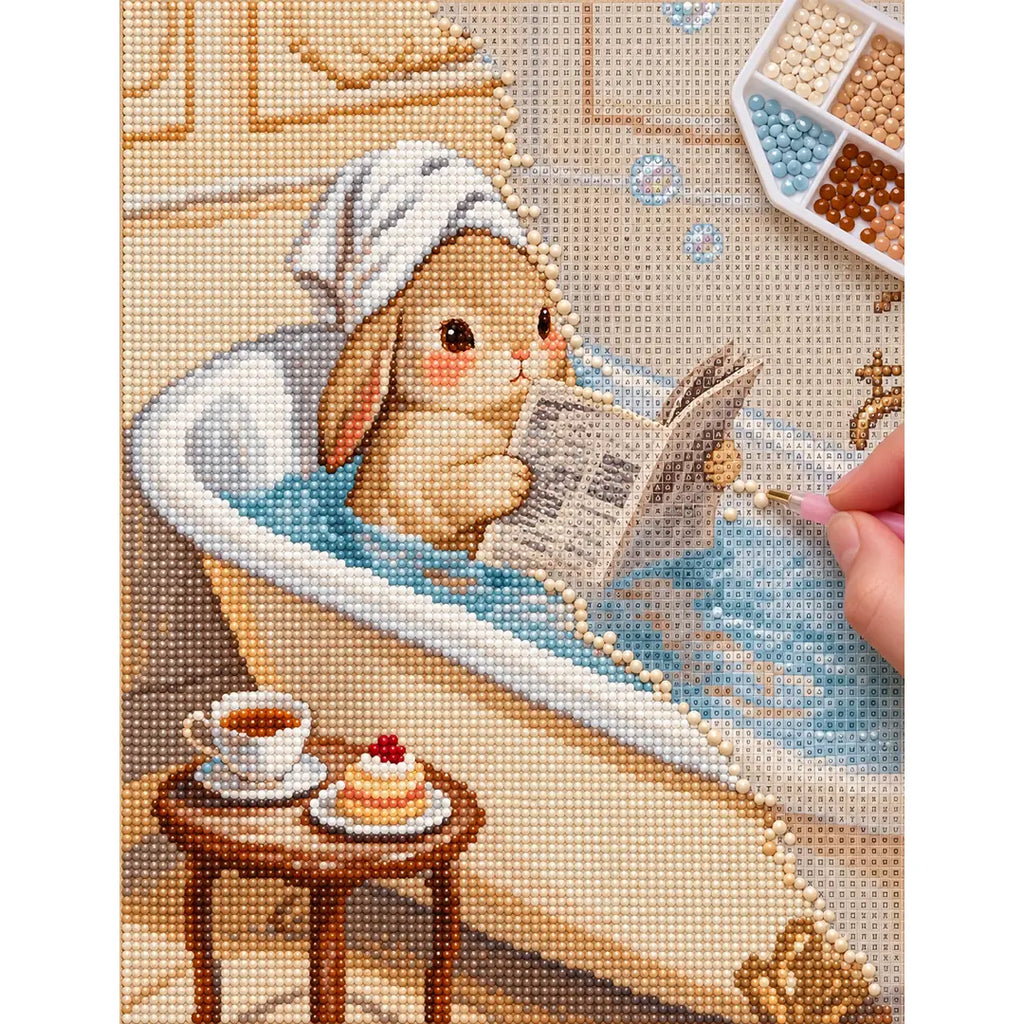 Diamond painting process showing a bunny reading in a bathtub being completed with a stylus