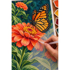 Hand placing diamond drills on the orange zinnia and monarch butterfly diamond painting canvas.