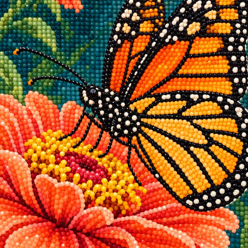 Close-up of sparkling drills forming the monarch butterfly and orange zinnia petals.