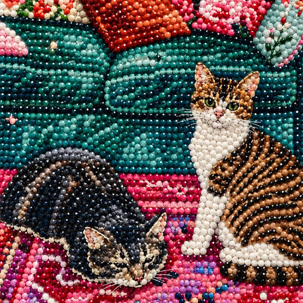 Close-up diamond drill detail of two cats resting in a floral room