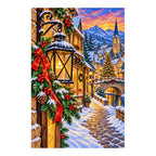 Finished diamond painting of a snowy Christmas village and glowing lantern