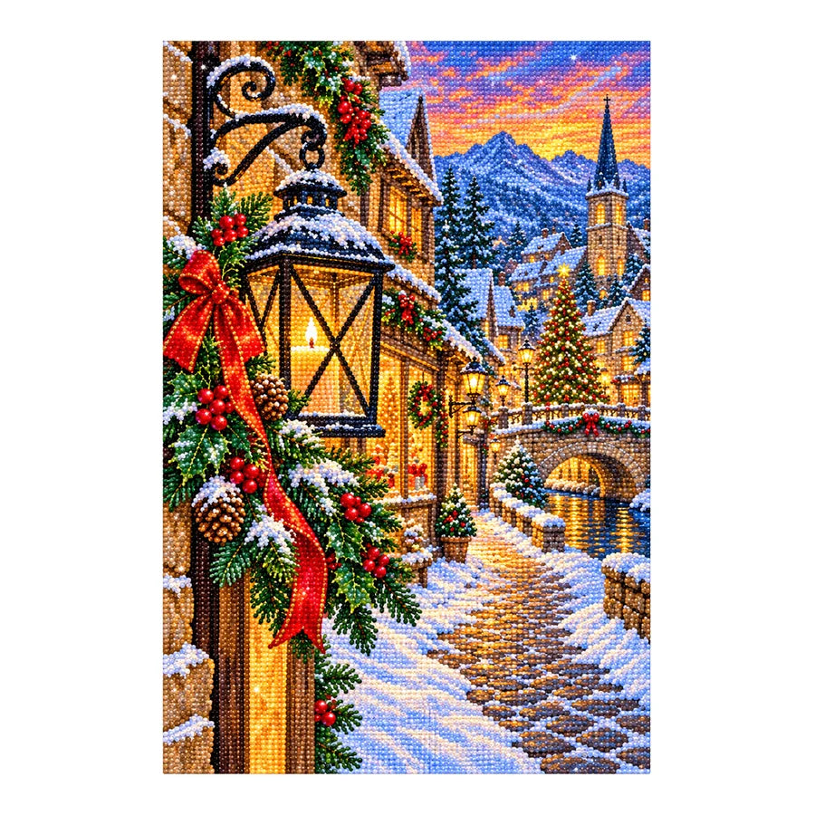 Finished diamond painting of a snowy Christmas village and glowing lantern