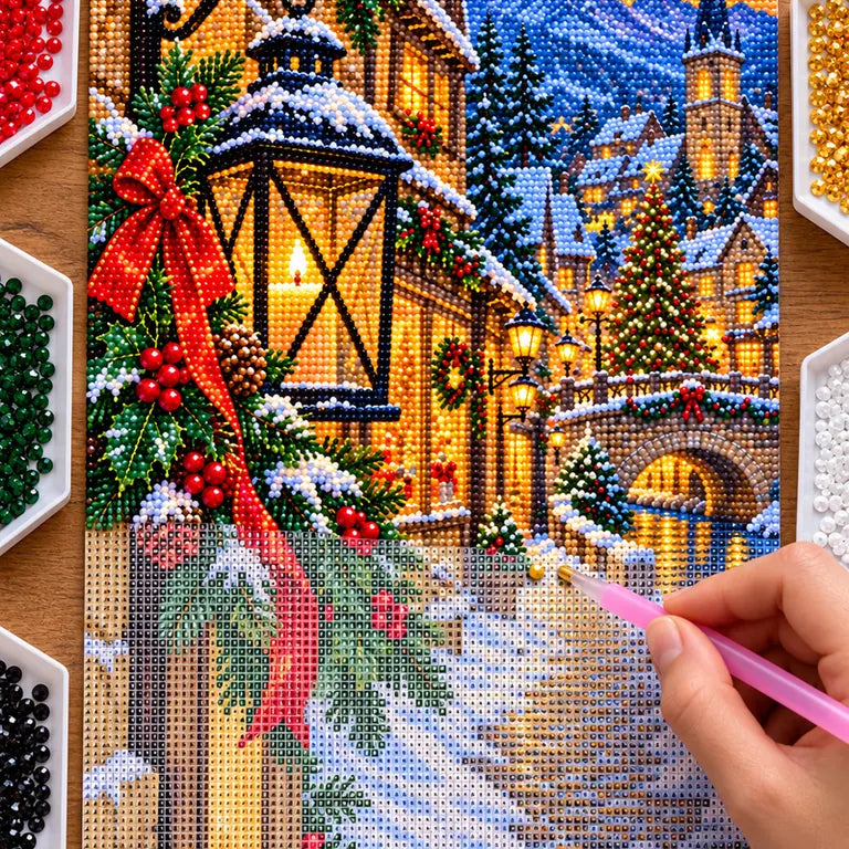 Hands placing drills on the Christmas village lantern diamond painting