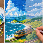 Diamond painting process for Coastal Curve Diamond Painting Kit, with hands applying drills over a yellow train winding beside turquoise surf and green coastal cliffs.