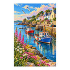 Finished diamond painting of colorful harbor boats, seaside houses, and coastal flowers on a white background.