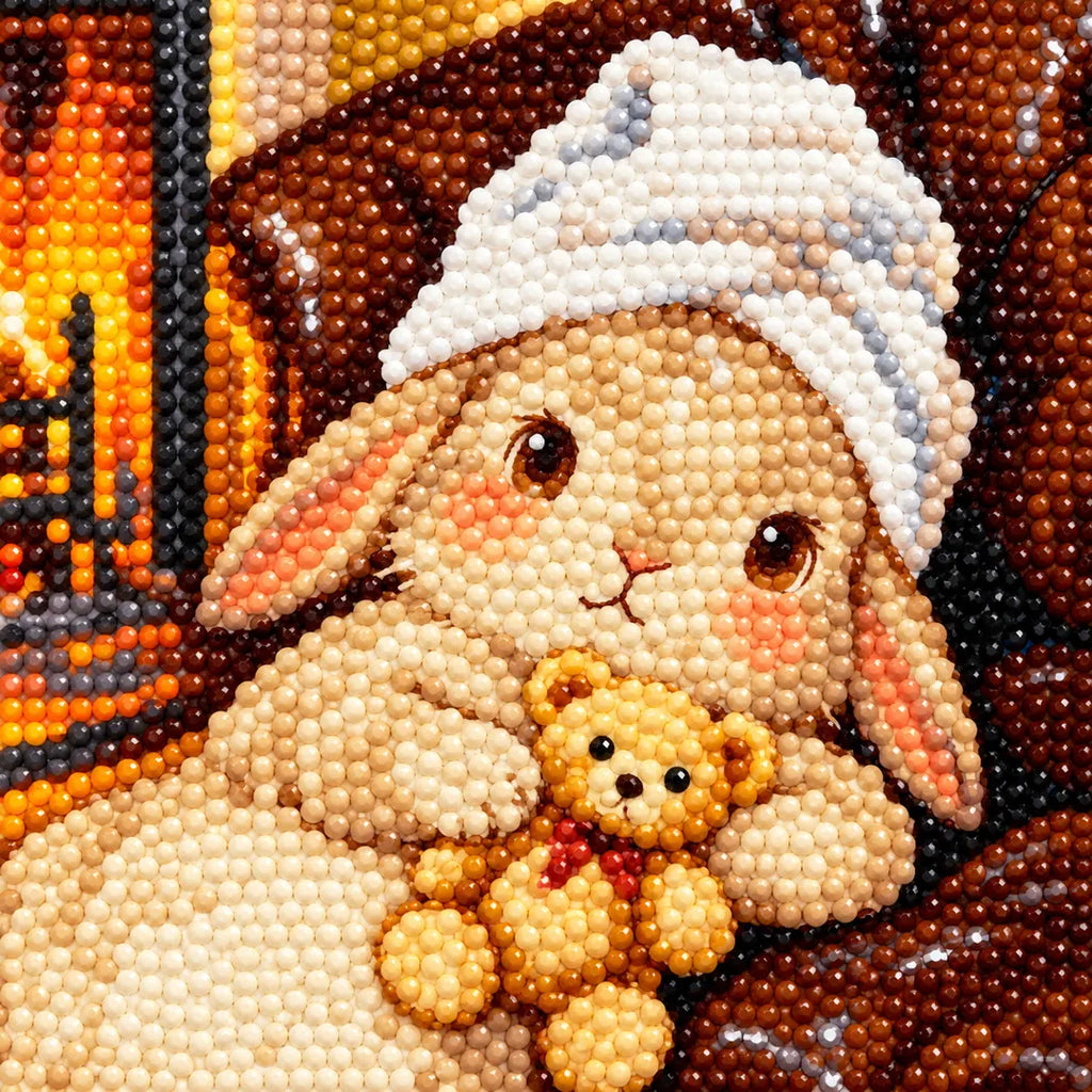 Close-up diamond drill detail of the knit-cap bunny cuddling a small teddy bear