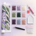 Complete diamond painting kit arranged on a pale background